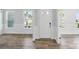 Bright entryway with white trim, wood floors, and a view of the yard through the windows at 3253 Mcharney Dr # 27, Harrisburg, NC 28075