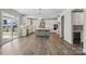 Spacious kitchen with white cabinets, gray island, stainless appliances, and hardwood flooring at 3253 Mcharney Dr # 27, Harrisburg, NC 28075