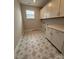 A practical laundry room boasts stylish star-patterned tile flooring and ample cabinet space for efficient storage solutions at 3253 Mcharney Dr # 27, Harrisburg, NC 28075