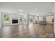 Open-concept living room featuring a fireplace and a view of the kitchen and backyard at 3253 Mcharney Dr # 27, Harrisburg, NC 28075