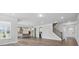 Spacious open concept showcasing the kitchen, living room, and staircase with sleek hardwood floors at 3253 Mcharney Dr # 27, Harrisburg, NC 28075