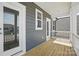 View of the porch with wood flooring, railing, and multiple exterior doors at 3253 Mcharney Dr # 27, Harrisburg, NC 28075
