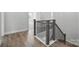 Elegant staircase with wooden handrail and wrought iron spindles, enhancing the home's character at 3253 Mcharney Dr # 27, Harrisburg, NC 28075