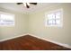 A bright bedroom has hardwood floors and two windows at 611 Greenbriar Ave, Rock Hill, SC 29730