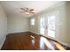 Cozy bedroom features a ceiling fan, hardwood floors, and a view to the backyard at 611 Greenbriar Ave, Rock Hill, SC 29730