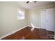 A cozy bedroom featuring hardwood floors, neutral walls, a bright window, and a closet with bi-fold doors at 611 Greenbriar Ave, Rock Hill, SC 29730