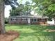 Charming single-story brick home with a well-manicured lawn and a classic white front door at 611 Greenbriar Ave, Rock Hill, SC 29730