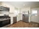 Bright kitchen with stainless steel appliances, new cabinets, and wood-look flooring at 611 Greenbriar Ave, Rock Hill, SC 29730