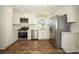 Modern kitchen with stainless steel appliances, white cabinets, and wood-look flooring at 611 Greenbriar Ave, Rock Hill, SC 29730