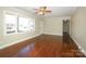 Bright living room boasts hardwood floors, large windows, and a ceiling fan at 611 Greenbriar Ave, Rock Hill, SC 29730