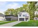 Two story home with a modern farmhouse design and dark gray garage door at 3627 Avalon Ave, Charlotte, NC 28208