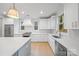 Bright kitchen featuring white cabinets and hardwood floors at 3627 Avalon Ave, Charlotte, NC 28208