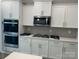 Modern kitchen with white cabinets, stainless steel appliances, and herringbone backsplash at 6019 Treehouse Dr, Charlotte, NC 28214