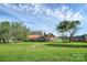 A backyard with lush grass, mature trees, a brick house, and a small shed at 106 Cameron Dr, Kings Mountain, NC 28086