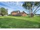 Spacious backyard with a lush lawn, mature trees, and an inviting deck at 106 Cameron Dr, Kings Mountain, NC 28086