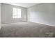 Spacious bedroom features neutral walls, carpeted floor, and a window letting in natural light at 106 Cameron Dr, Kings Mountain, NC 28086