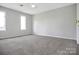 Spacious bedroom features neutral walls, carpeted floor, and two windows letting in natural light at 106 Cameron Dr, Kings Mountain, NC 28086