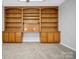 Bedroom features built-in bookshelves and cabinets, neutral paint, and carpeted floor at 106 Cameron Dr, Kings Mountain, NC 28086