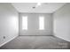 Bright bedroom with neutral colored carpet and walls with two windows at 106 Cameron Dr, Kings Mountain, NC 28086