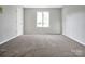 Bedroom with neutral colored carpet and walls with one window at 106 Cameron Dr, Kings Mountain, NC 28086