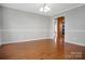 Dining room features hardwood floors, neutral paint, white molding, and traditional chandelier lighting at 106 Cameron Dr, Kings Mountain, NC 28086