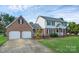 Charming brick and siding home with a well-manicured lawn and two-car garage at 106 Cameron Dr, Kings Mountain, NC 28086