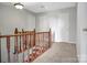Upstairs hallway with carpet and wooden railing at 106 Cameron Dr, Kings Mountain, NC 28086