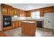 Traditional kitchen with wood cabinets, tile floors, and a center island at 106 Cameron Dr, Kings Mountain, NC 28086