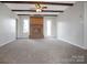 Spacious living room features exposed wood beams, brick fireplace, and neutral carpeting at 106 Cameron Dr, Kings Mountain, NC 28086
