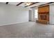 Spacious living room features exposed wood beams, brick fireplace, and neutral carpeting at 106 Cameron Dr, Kings Mountain, NC 28086