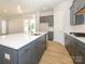 Modern kitchen with gray cabinetry, quartz countertops, and island at 1014 Lowland Way, Waxhaw, NC 28173