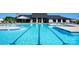 Community lap pool with lounge chairs and clubhouse at 1014 Lowland Way, Waxhaw, NC 28173