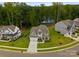 Aerial view of a well-maintained home with lush landscaping and a beautiful lake in the background at 6034 Jepson Ct, Charlotte, NC 28214