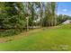 Expansive backyard with mature trees and lush green lawn, perfect for outdoor enjoyment at 6034 Jepson Ct, Charlotte, NC 28214