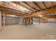 Spacious unfinished basement with exposed ceiling and concrete flooring, awaiting customization at 6034 Jepson Ct, Charlotte, NC 28214