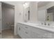 Bathroom with double vanity, modern fixtures, and a linen closet at 6034 Jepson Ct, Charlotte, NC 28214