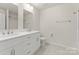 Bathroom featuring a double sink vanity, toilet, and shower/tub combo at 6034 Jepson Ct, Charlotte, NC 28214