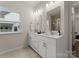 Bright bathroom boasts double vanity with storage and granite counters at 6034 Jepson Ct, Charlotte, NC 28214