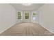 Well-lit bonus room with three large windows and neutral carpeting at 6034 Jepson Ct, Charlotte, NC 28214