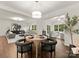 Open dining room concept with wood floors, view to living room, and contemporary décor at 6034 Jepson Ct, Charlotte, NC 28214