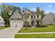 Charming two-story home with a manicured front lawn and attached two-car garage at 6034 Jepson Ct, Charlotte, NC 28214
