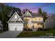 Beautiful two-story home featuring a manicured lawn and two-car garage at 6034 Jepson Ct, Charlotte, NC 28214