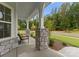 Cozy front porch with stone accents, decorative columns, and a comfortable bench seating area at 6034 Jepson Ct, Charlotte, NC 28214