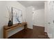 Inviting hallway with wood floors, elegant console table, and neutral wall color at 6034 Jepson Ct, Charlotte, NC 28214