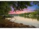 Beautiful sunset view of a lake with boat docks and waterfront homes in the background at 6034 Jepson Ct, Charlotte, NC 28214