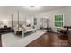 Spacious main bedroom features wood flooring, a sitting area, and natural light at 6034 Jepson Ct, Charlotte, NC 28214