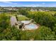 Aerial view of community pool and recreational area, with trees, a water slide, and seating at 6034 Jepson Ct, Charlotte, NC 28214