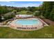Aerial view of community pool featuring a slide and lap pool with shaded seating and landscaping at 6034 Jepson Ct, Charlotte, NC 28214