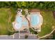 Overhead view of pools, slides, and a clubhouse with ample parking, showcasing community amenities at 6034 Jepson Ct, Charlotte, NC 28214
