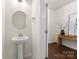 Clean powder room featuring a pedestal sink, modern fixtures, and neutral décor at 6034 Jepson Ct, Charlotte, NC 28214